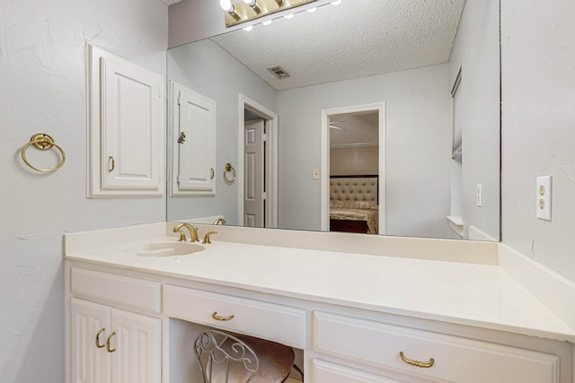 bathroom with vanity and a textured ceiling