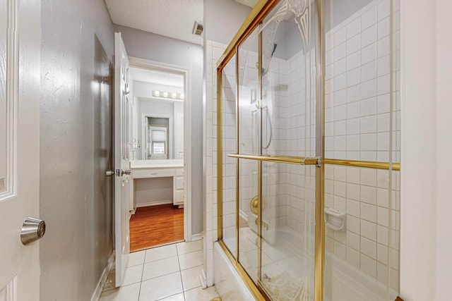 bathroom featuring enclosed tub / shower combo and hardwood / wood-style flooring