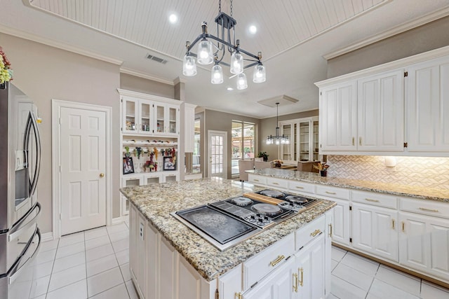 kitchen featuring hanging light fixtures, stainless steel fridge with ice dispenser, black gas cooktop, white cabinetry, and a center island