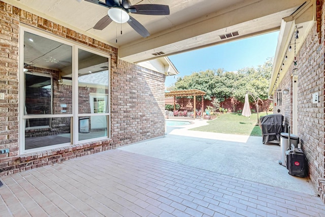 view of patio / terrace featuring a fenced in pool and ceiling fan