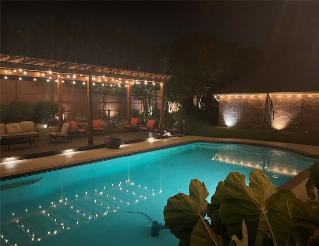 pool at twilight featuring a patio