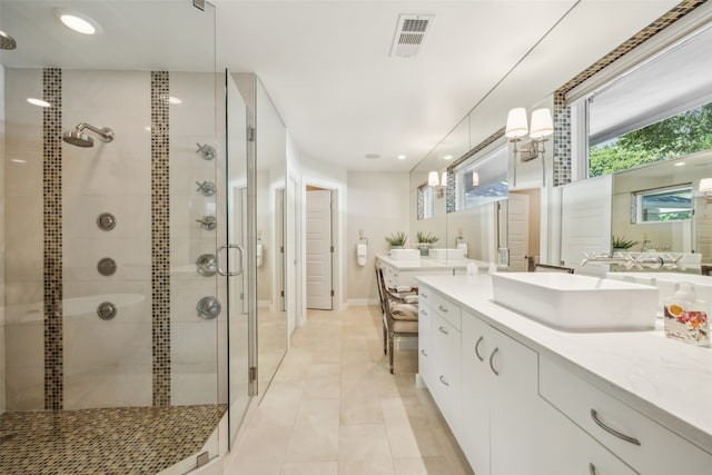 bathroom with vanity, tile patterned flooring, and walk in shower