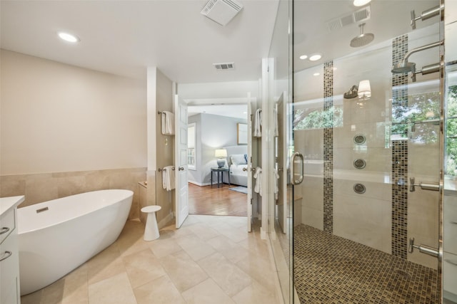 5332 Edmondson Ave, Dallas, TX 75209 - ensuite bathroom with a shower stall, a freestanding tub, vanity, tile patterned floors, and recessed lighting