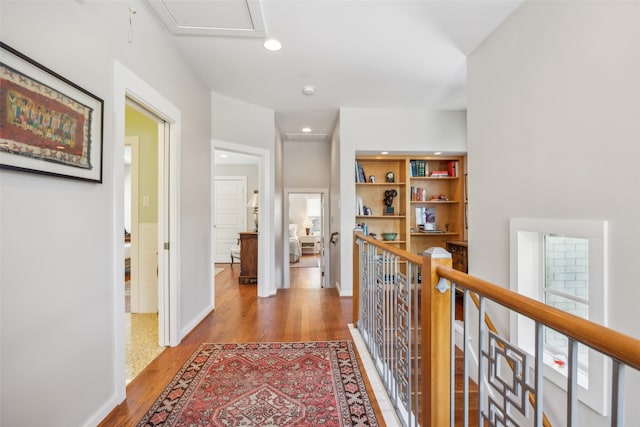 corridor with light hardwood / wood-style floors