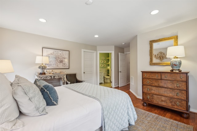 bedroom with dark hardwood / wood-style flooring and ensuite bathroom