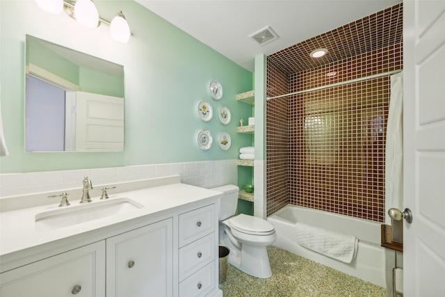 full bathroom featuring vanity, shower / bath combo, and toilet