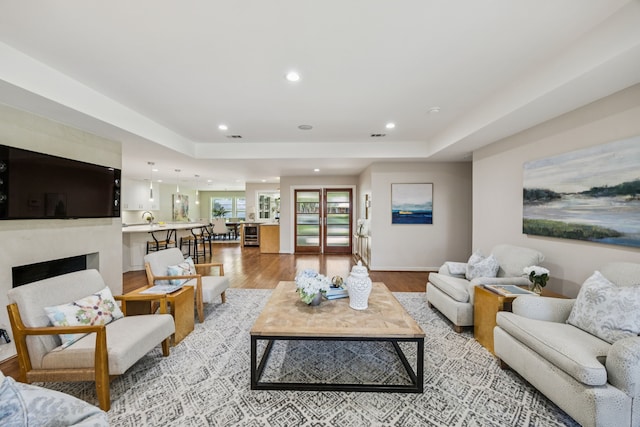 5332 Edmondson Ave, Dallas, TX 75209 - living area featuring light wood-type flooring, recessed lighting, a fireplace, and a tray ceiling