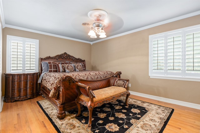 bedroom with ceiling fan, light hardwood / wood-style flooring, multiple windows, and crown molding