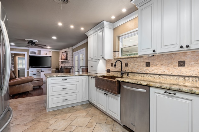 kitchen with dishwasher, ceiling fan, backsplash, white cabinetry, and light hardwood / wood-style floors