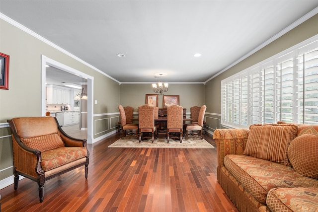 dining space with crown molding, hardwood / wood-style flooring, and a chandelier