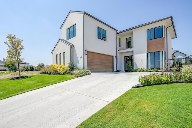 contemporary house with a garage and a front lawn