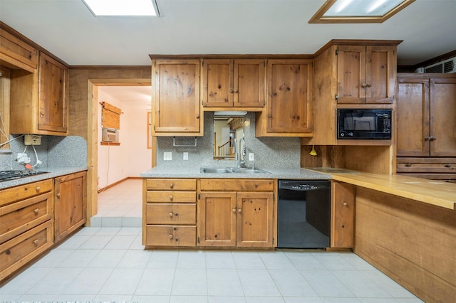 kitchen with cooling unit, sink, black appliances, and tasteful backsplash