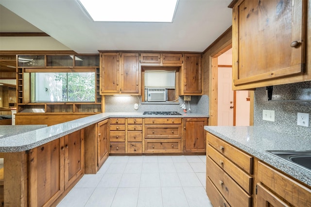 kitchen with black gas stovetop, cooling unit, decorative backsplash, and light tile patterned floors