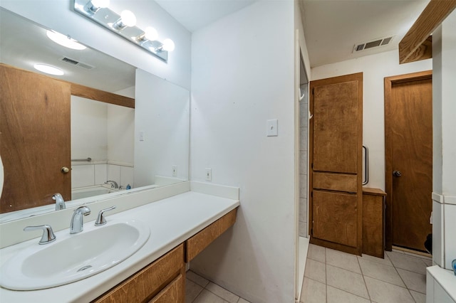 bathroom with tile patterned flooring and vanity