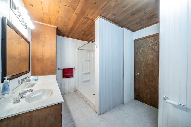 bathroom with a shower, tile patterned flooring, wood ceiling, and vanity