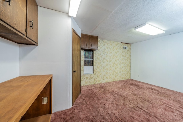 kitchen with carpet floors and a textured ceiling