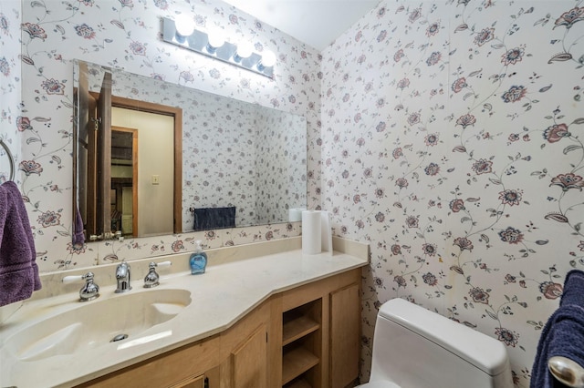 bathroom with toilet and vanity