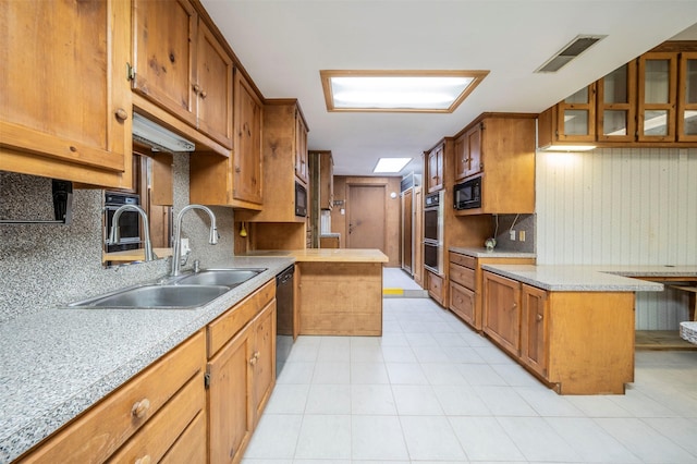 kitchen with a center island, decorative backsplash, sink, and black appliances