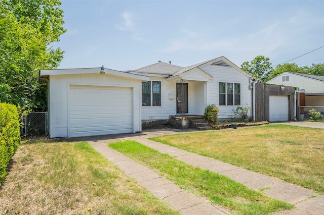 ranch-style home with a front yard and a garage