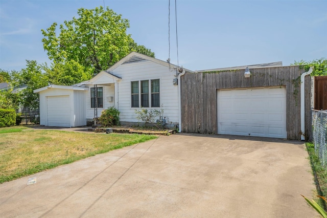 ranch-style home featuring a garage and a front yard