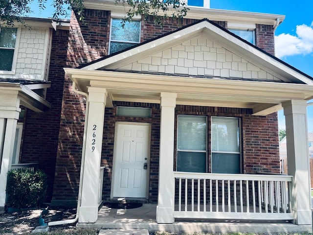 property entrance with covered porch