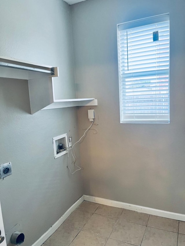 clothes washing area with washer hookup and light tile patterned floors