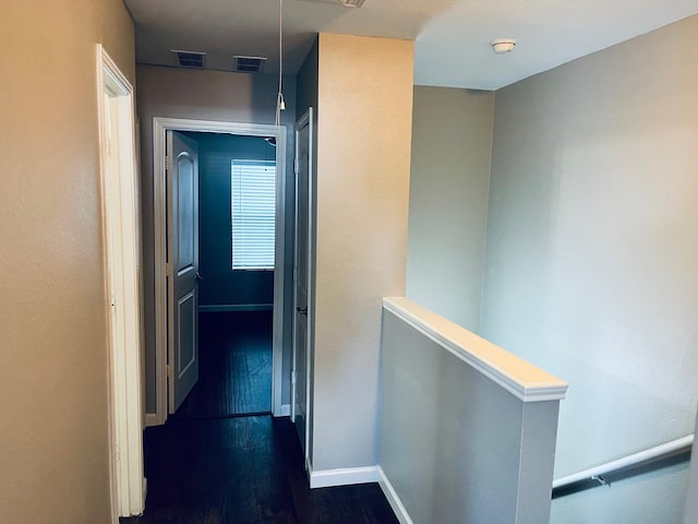 corridor featuring dark hardwood / wood-style flooring