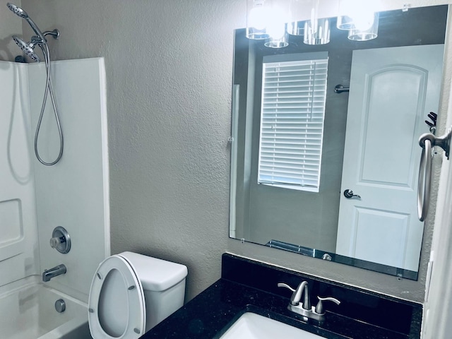 full bathroom featuring vanity, toilet, and washtub / shower combination