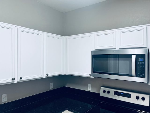 kitchen with white cabinetry and range