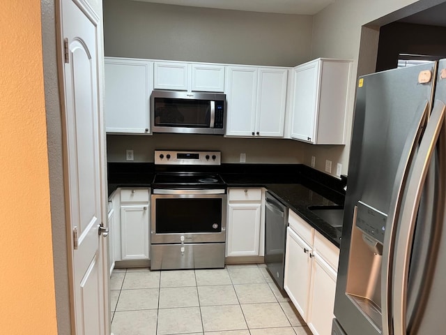 kitchen with white cabinetry, appliances with stainless steel finishes, and light tile patterned floors