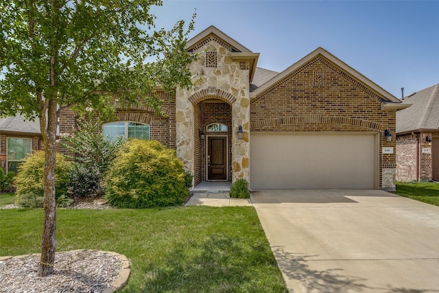 view of front of property with a garage and a front lawn