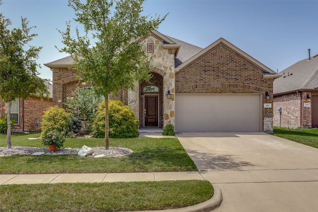 view of front of property with a garage and a front lawn