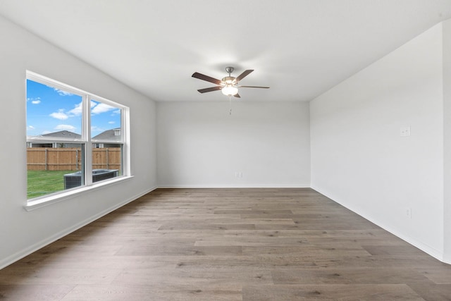 spare room with hardwood / wood-style floors and ceiling fan