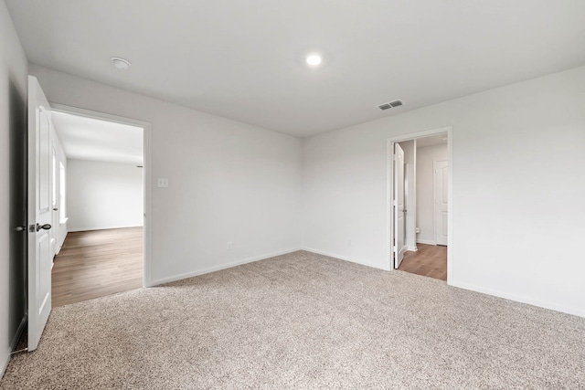 unfurnished room featuring light carpet