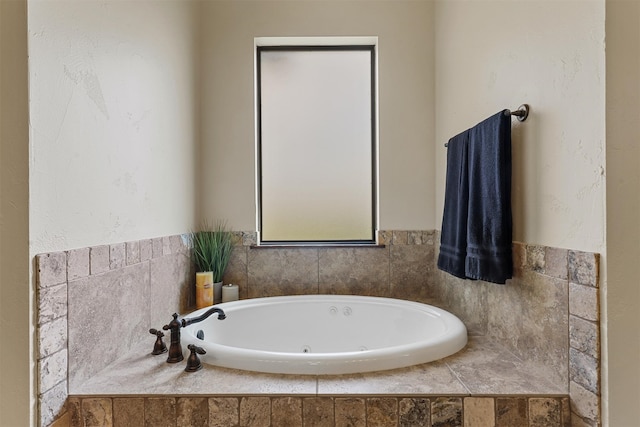 bathroom with a relaxing tiled tub