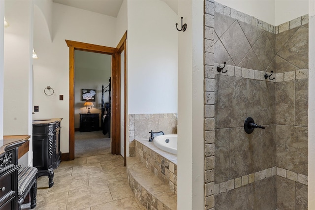 bathroom featuring vanity and independent shower and bath