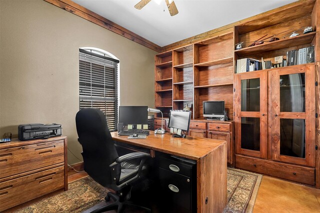 office area featuring ceiling fan and crown molding