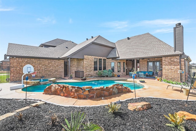 view of pool with a patio and an in ground hot tub