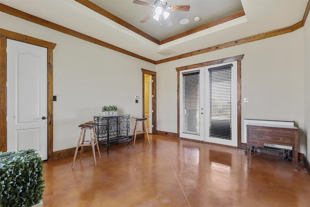 interior space featuring french doors, a tray ceiling, and ceiling fan