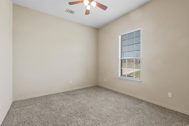 carpeted spare room with ceiling fan