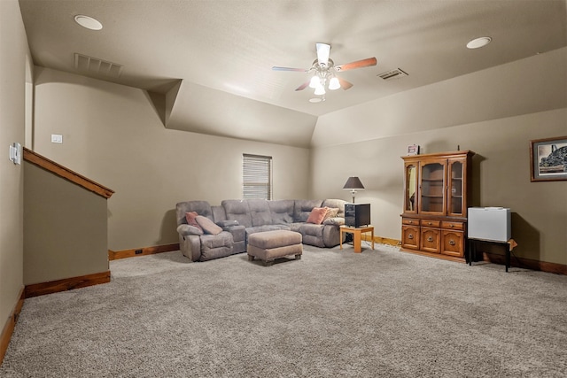 carpeted living room with ceiling fan and vaulted ceiling