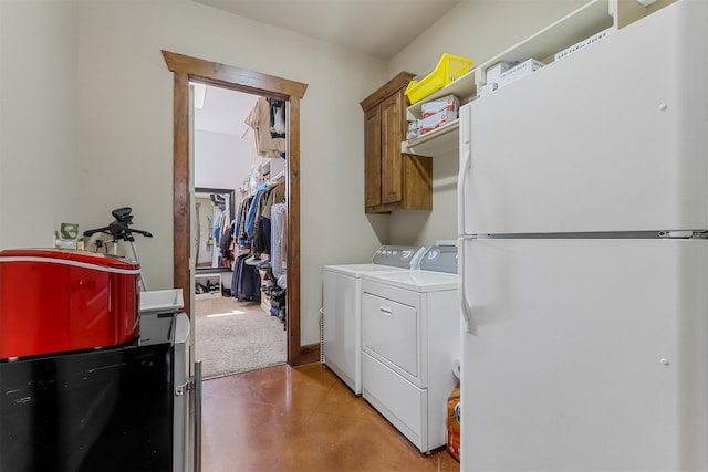 clothes washing area with independent washer and dryer and cabinets