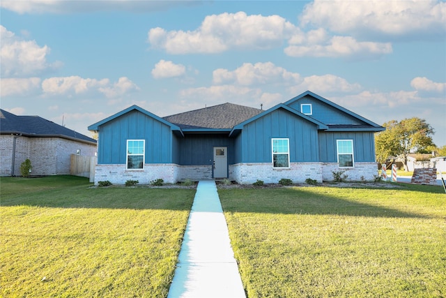 1412 Mason St, Bowie, TX 76230 - ranch-style house with board and batten siding, brick siding, and a front lawn