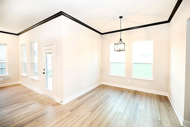 unfurnished dining area with crown molding, light hardwood / wood-style flooring, and a chandelier