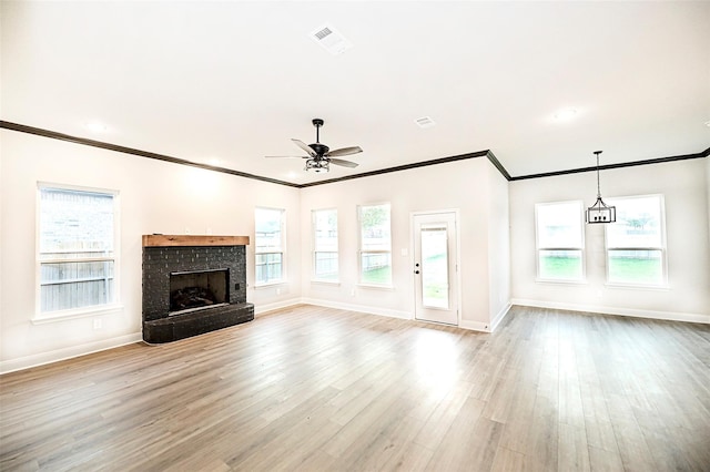 1412 Mason St, Bowie, TX 76230 - unfurnished living room with ornamental molding, baseboards, a ceiling fan, light wood-type flooring, and a brick fireplace