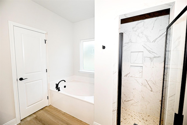 bathroom featuring wood-type flooring and plus walk in shower