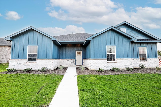 1412 Mason St, Bowie, TX 76230 - view of front of home featuring board and batten siding, a front lawn, a shingled roof, and brick siding