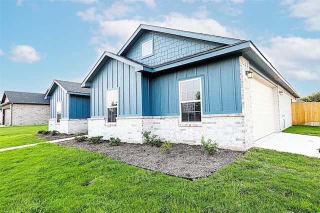 view of side of home featuring a lawn and a garage