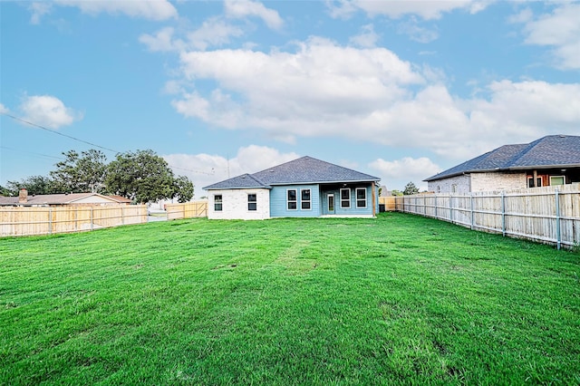 back of house with a lawn