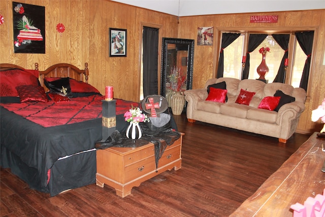 bedroom with wood walls and wood finished floors